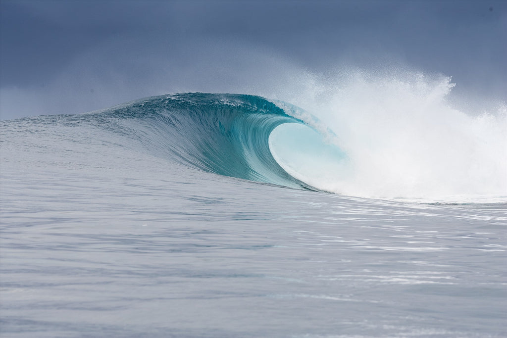 A clear blue wave about to break