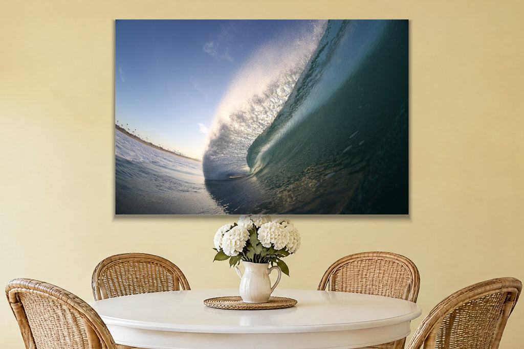 A steep blue wave face lit from behind with a curved horizon line shown large on the wall of a lived-in room