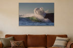 A wave exploding into a cloud of spray against a dark cliff shown large on the wall of a lived-in room
