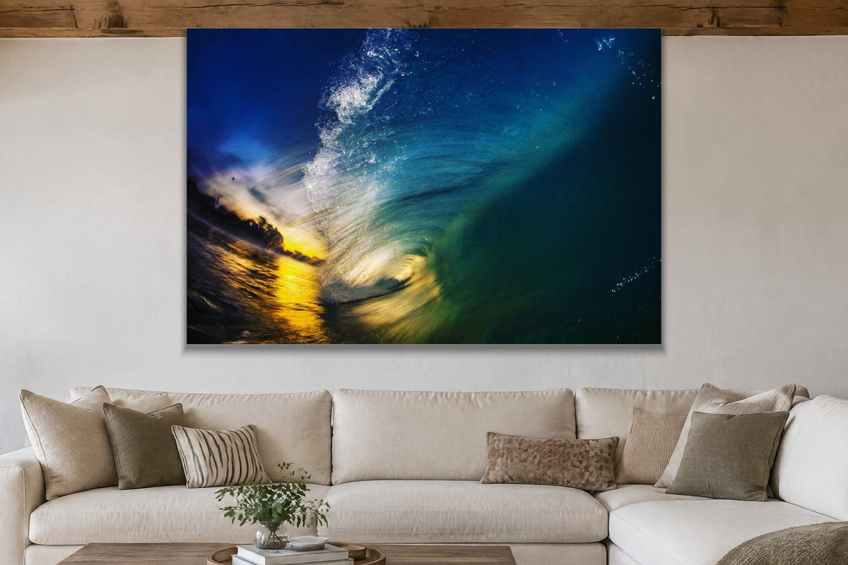 Inside a dark blue wave with golden sunset light at the opening shown large on the wall of a lived-in room
