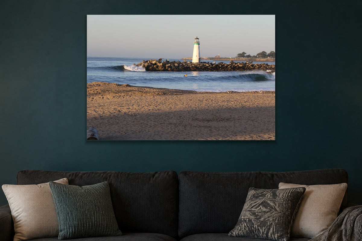 Lighthouse Morning metal print hanging above furniture in a living space