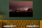 Lightning Over the Lighthouse metal print hanging above furniture in a living space