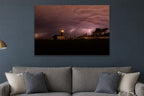 Lightning Over the Lighthouse metal print hanging above furniture in a living space