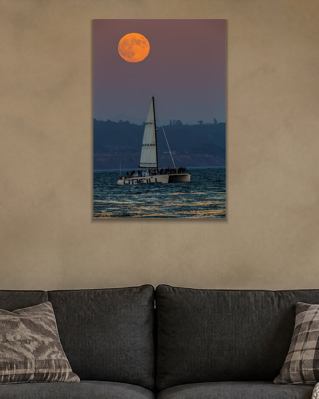 Moon and the Boat metal print hanging above furniture in a living space