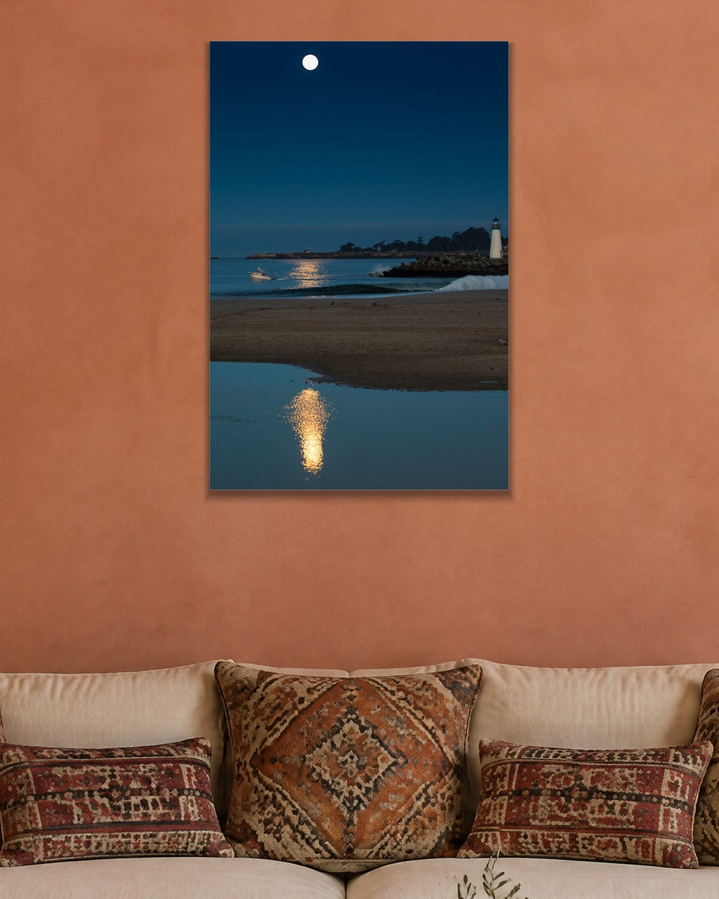 Moon Over the Lighthouse metal print hanging above furniture in a living space