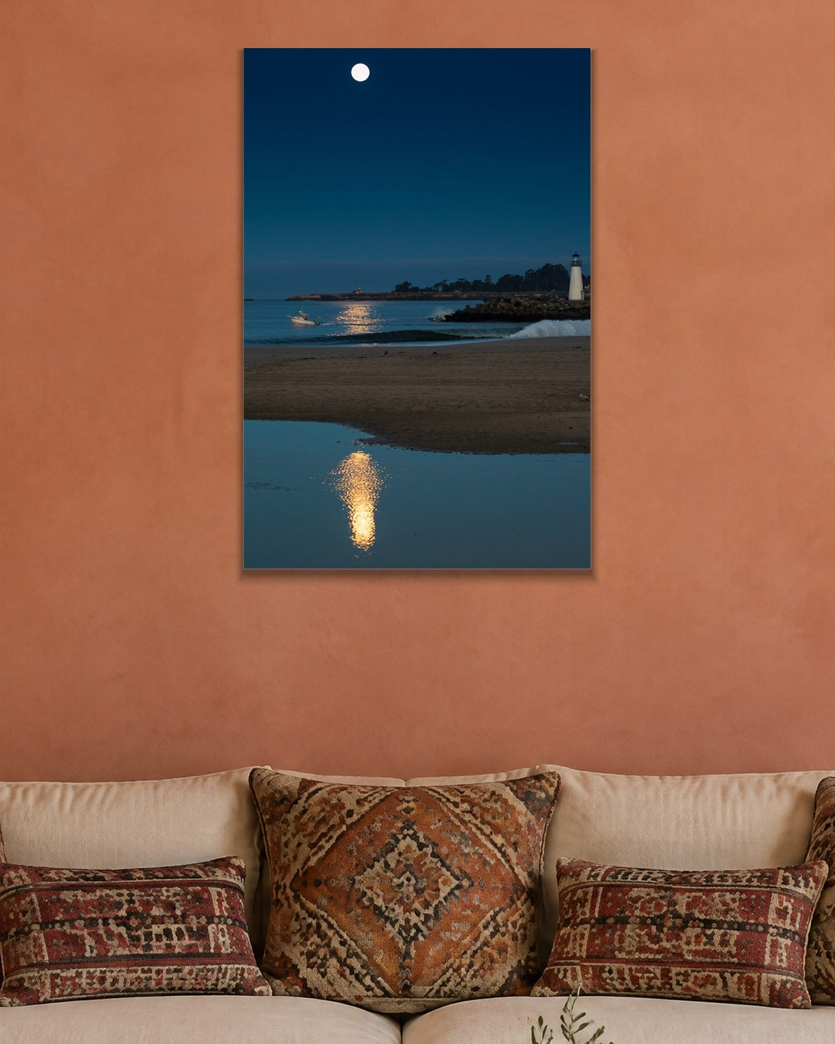 Moon Over the Lighthouse metal print hanging above furniture in a living space