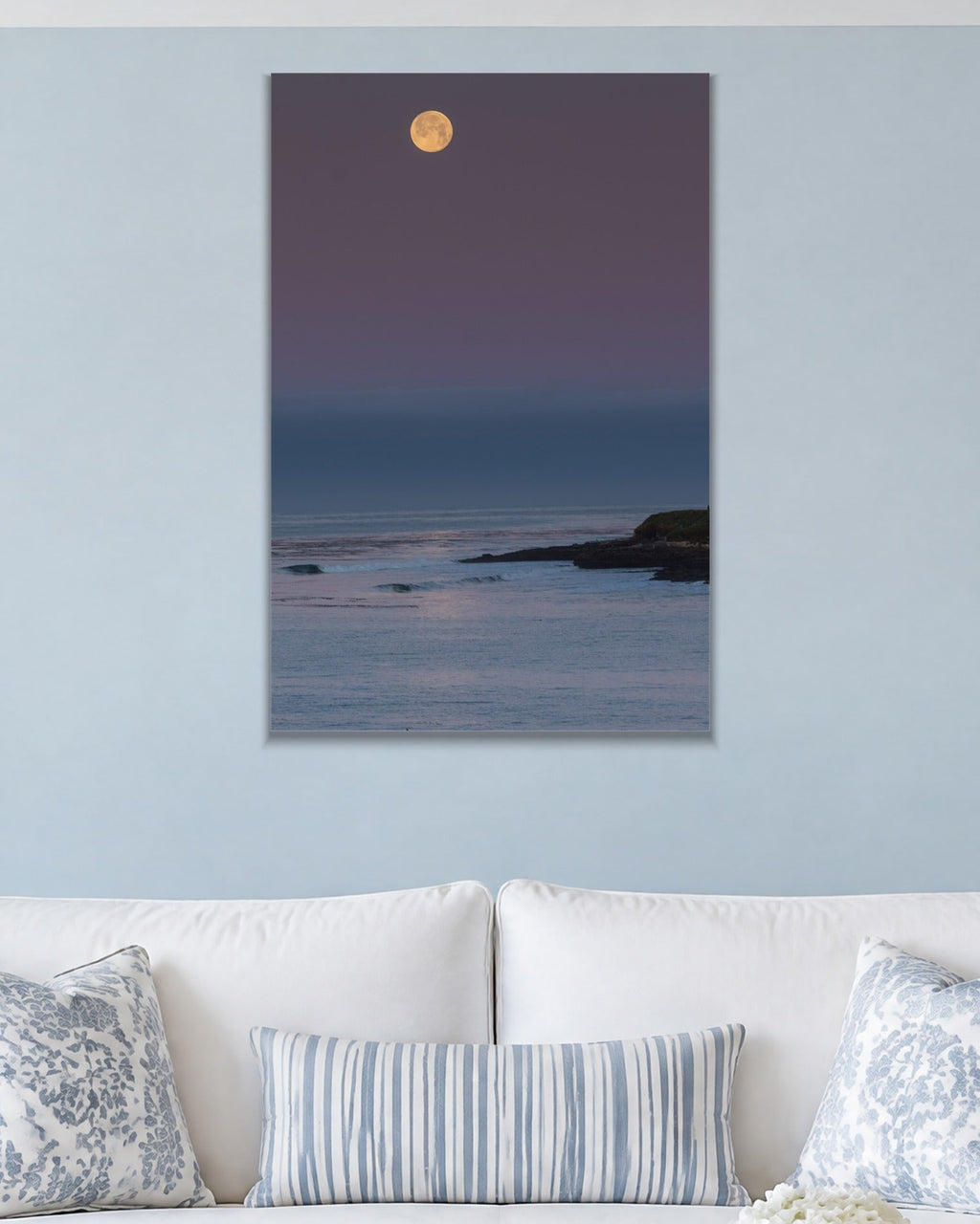 Moonrise metal print hanging above furniture in a living space