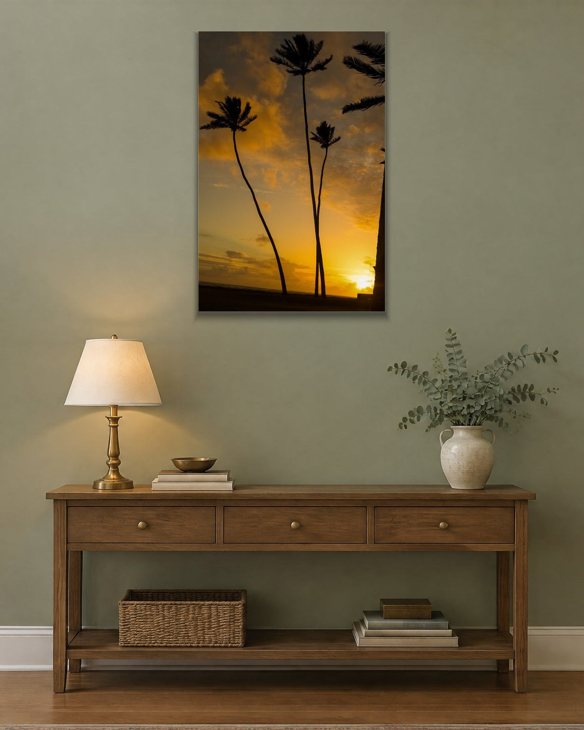 Silhouetted palm trees against a glowing orange and gold sunset shown large on the wall of a lived-in room