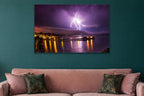 Lightning Over the Pier metal print hanging above furniture in a living space