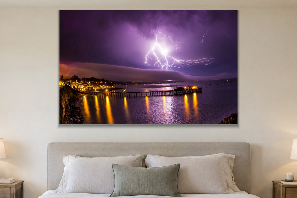 Lightning Over the Pier metal print hanging above furniture in a living space