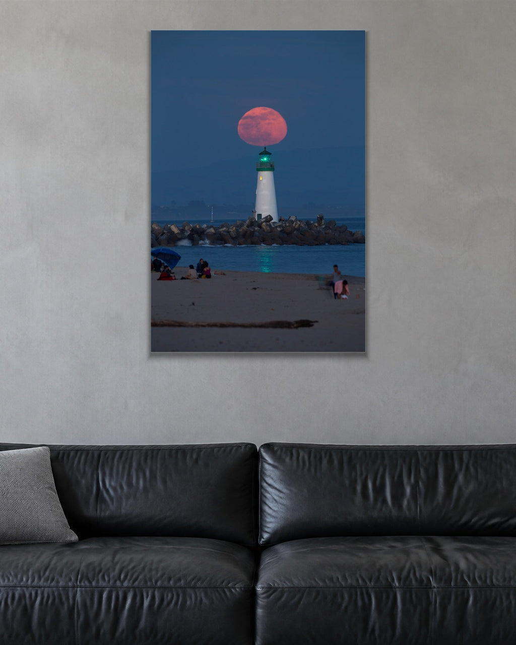Red Moon Lighthouse metal print hanging above furniture in a living space