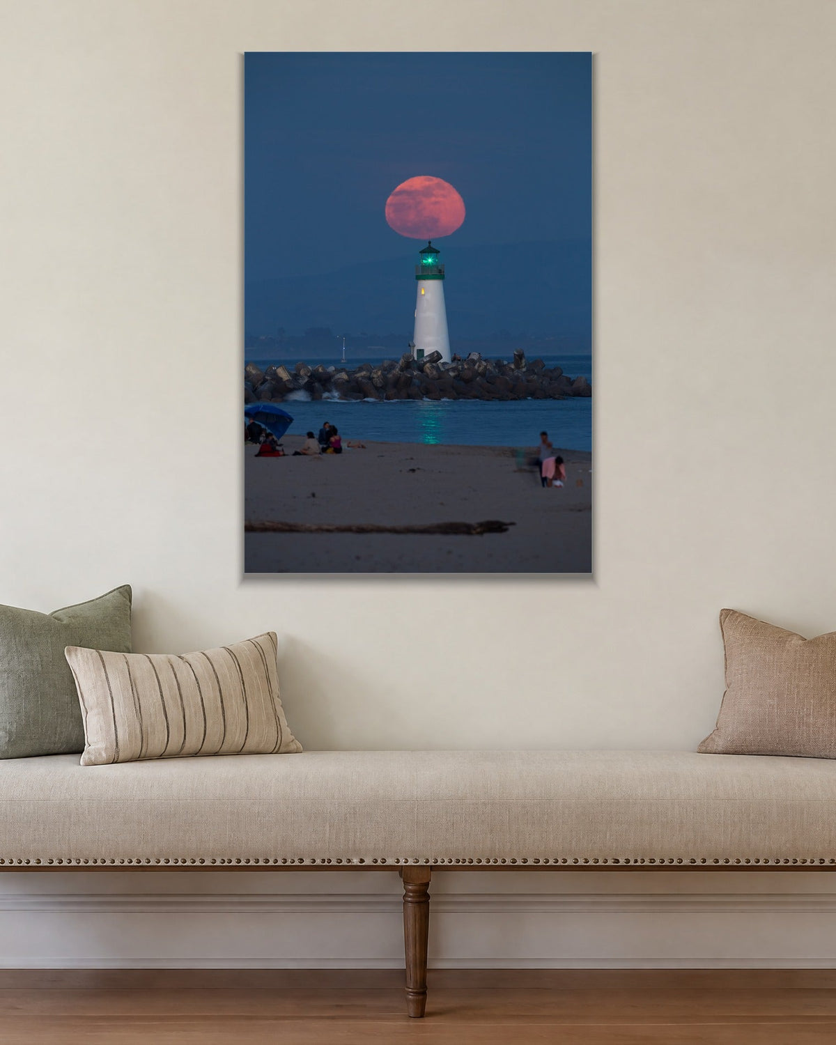 Red Moon Lighthouse metal print hanging above furniture in a living space