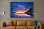 A sunset sky of purple and orange clouds reflected in a still puddle on the beach shown large on the wall of a lived-in room