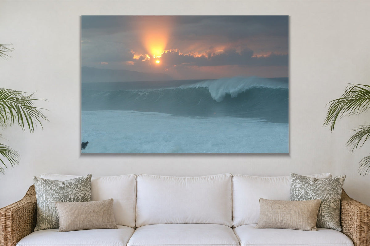 A glowing sun behind clouds above a peeling blue wave shown large on the wall of a lived-in room
