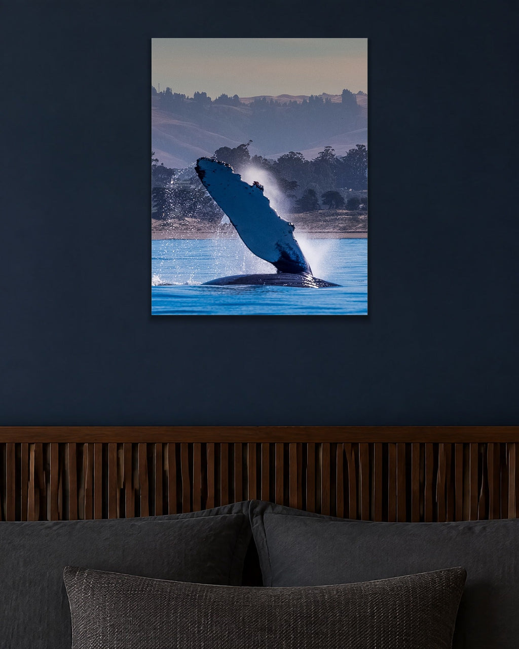 The Whale Wave metal print hanging above furniture in a living space