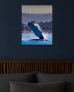 The Whale Wave metal print hanging above furniture in a living space